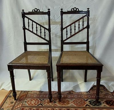 Pair of Straw Chairs
. Walnut wood with cane seat and back with balusters topped with a carved 