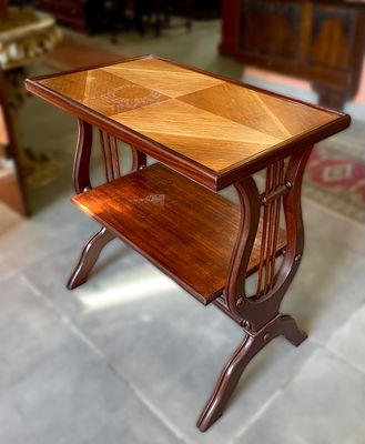 Walnut wood side table. Two trays supported by a wooden structure carved in relief to represent 