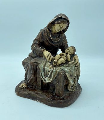 Statue of Virgin Mary with Child Jesus. Round clay statue of the Virgin Mary in various brown 