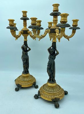 Pair of Candlesticks in Bronze. Pair of five-torch candlesticks in two-colour bronze. 
Circular 