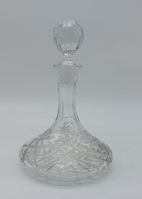 Glass Bottle
. Conical shaped body with faceted stopper, chiseled decoration in relief, with 