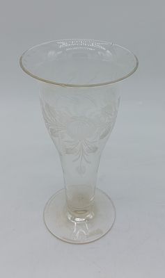 Glass Solitaire
. Conical shaped body supported on a round base, floral decoration chiseled in 