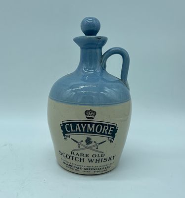 Faience bottle. Claymore Scotch Whiskey bottle, Scotland in moulded and relief faience with 