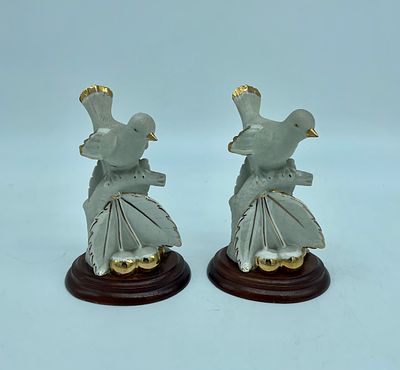 Pair of ceramic sculptures depicting birds on a cherry tree. Porcelain with gold detailing on a 