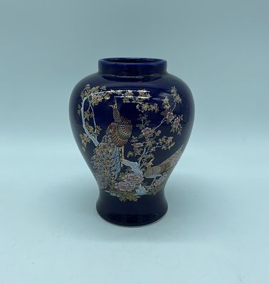 Japanese porcelain vase. Moulded porcelain with a cobalt blue base and polychrome painting. 