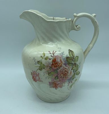 Faience vase. Moulded and relief faience vase. Polychrome painting of floral motifs on a white 