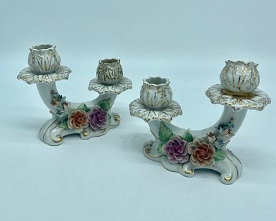 Pair of porcelain candlesticks. White porcelain with small biscuit flower sculptures and 