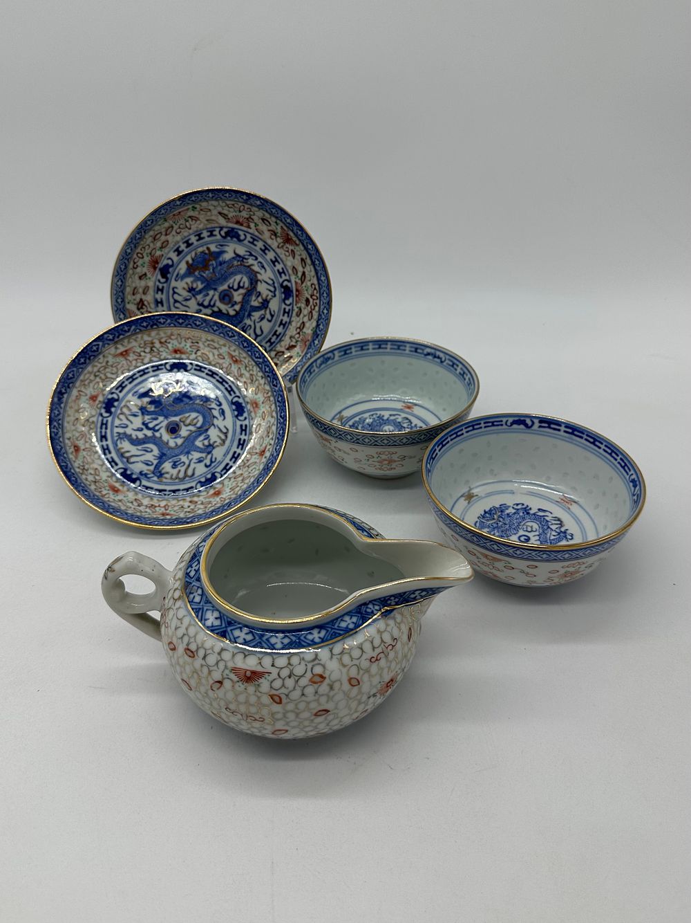 Five Pieces in Oriental Porcelain
. Molded and relief, marked on the base, milk jug and four 