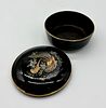 Porcelain box. Moulded and embossed porcelain box with lid. Circular black body with polychrome Image - 2