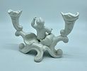 Ceramic candlestick. Moulded and embossed white ceramic candlestick depicting a boy and two Image - 1