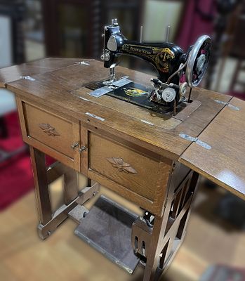 Wilson sewing machine cabinet. Original X Wilson piece, black sewing machine with polychrome 