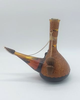 Bottle of Fortified Wine
. Amber glass bottle in the shape of a pipe, covered in leather with 