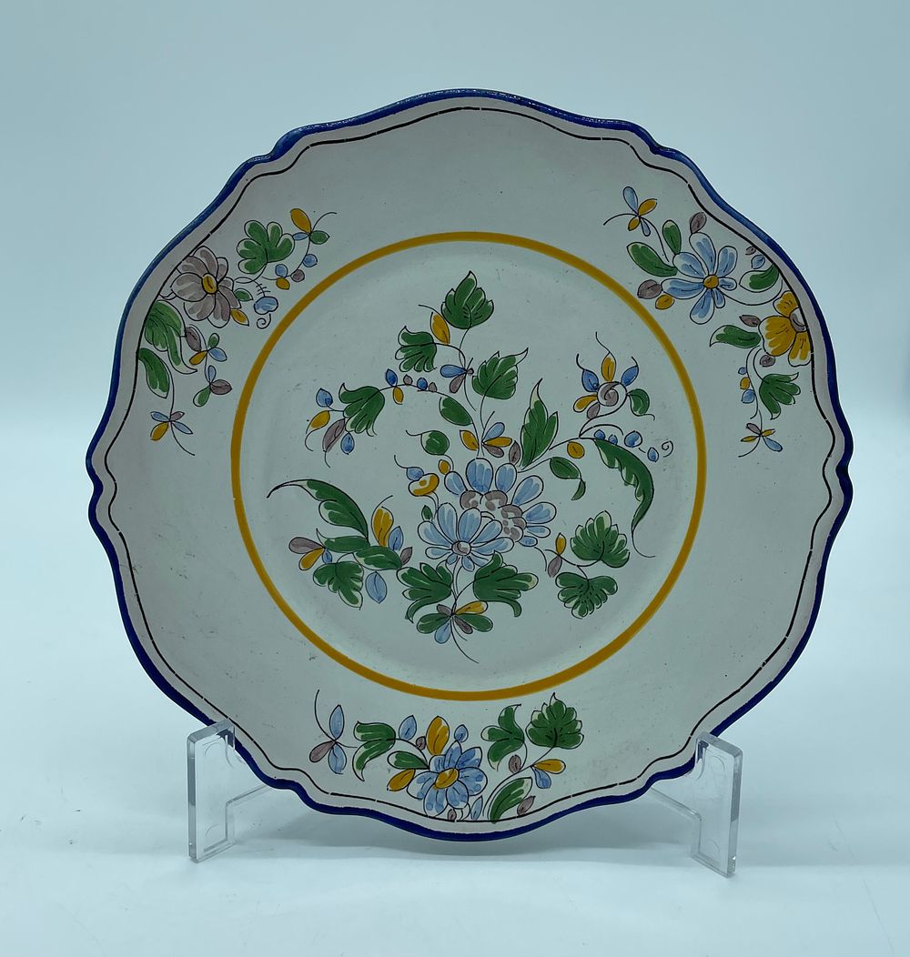 Decorative faience plate. Moulded and embossed faience with polychrome floral motif decoration. 