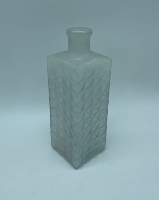 Cut frosted glass bottle. Rectangular-shaped body in frosted glass with relief and texture. 