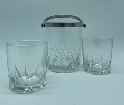 Ice bucket and two glass tumblers
. Ice bucket and two glass tumblers. Cylindrical bodies, ice 
