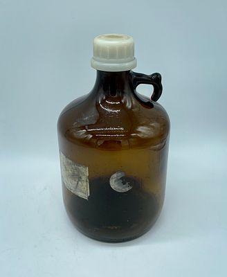 Amber glass bottle. Cylindrical amber glass bottle with handle and with plastic cap. 