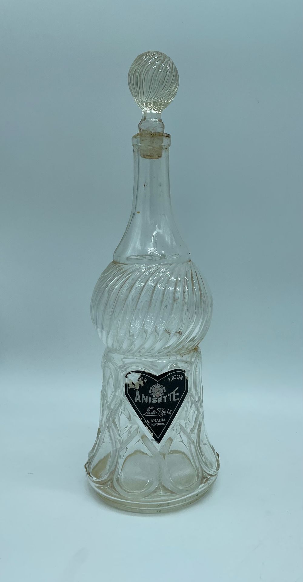 Glass bottle. Antique glass liqueur bottle with lid. Moulded glass, embossed and volumetrically 