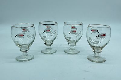 Four Glass Cups
. Four glass tumblers with conical-shaped bodies with feet and round bases. The 