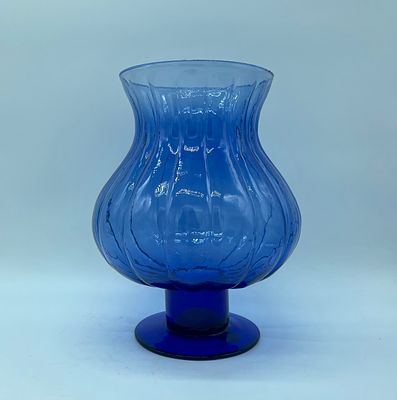 Blue glass vase. Vase with a bowl-shaped top resting on a moulded blue coloured glass base. 