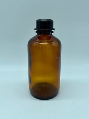 glass bottle. Amber glass cylindrical bottle with plastic cap. Manufactured by E. Merck 