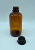 glass bottle. Amber glass cylindrical bottle with plastic cap. Manufactured by E. Merck Image - 1
