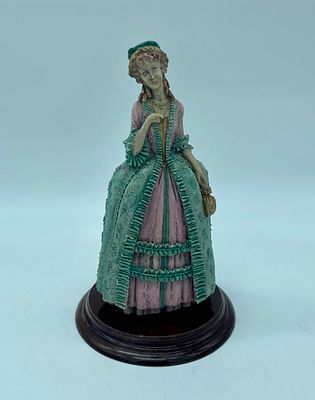 Ivory sculpture, moulded and unveiled. Re-presentation of a woman in polychromatic clothing. 
