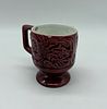 Portuguese faience mug. Moulded and embossed earthenware painted in shades of red on a white Image - 1