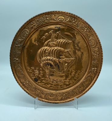 Brass Wall Plate
. Round body with molded and embossed rim, depicting a ship in the center. 