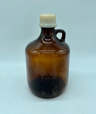 Glass bottle. Amber glass bottle with plastic lid. Marked on the side with: 711 118 2824 6. It 