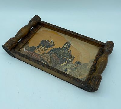 Wooden tray. Rectangular tray with raised wooden body and two handles. In the centre is a wood 