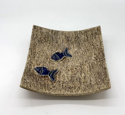 Decorative earthenware plate
. Molded and embossed, with a marked base, square-shaped body, with 