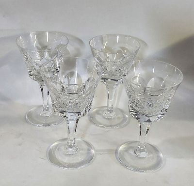 Four Cut Glass Cups
. Conical glass bodies, supported on a round base, showing signs of use, as 