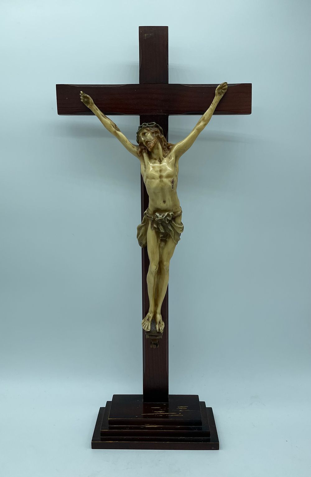 Crucifix with wooden base and cross and a polychrome painted ivory figure of Jesus Christ. The 