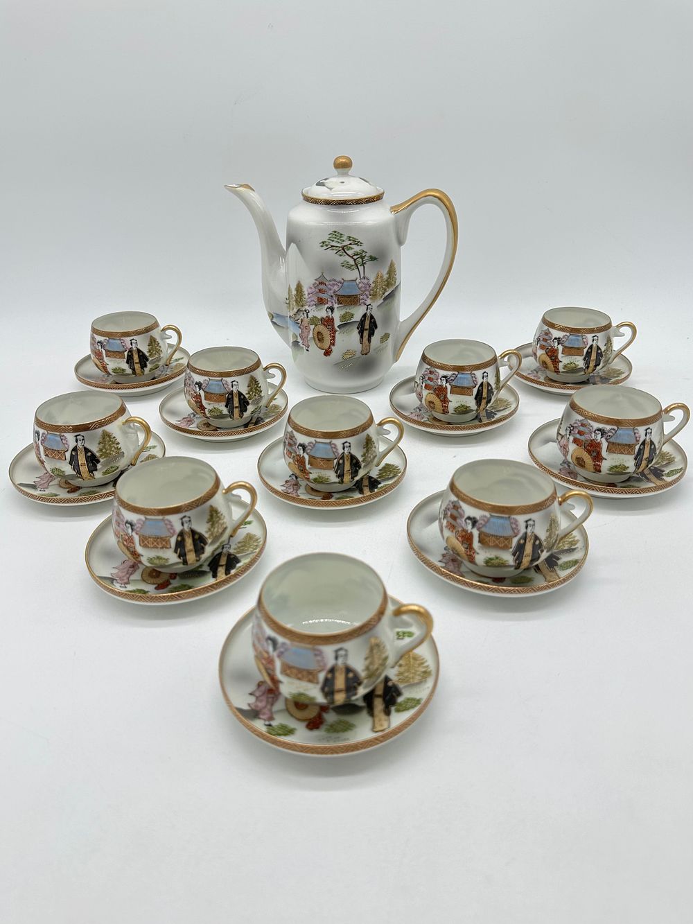 Oriental Porcelain Coffee Service
. Molded and relief, marked on the base, teapot and ten cups 