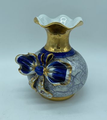 Porcelain vase. Bowl vase with wavy rim and bow sculpture on one side. Painted in shades of 