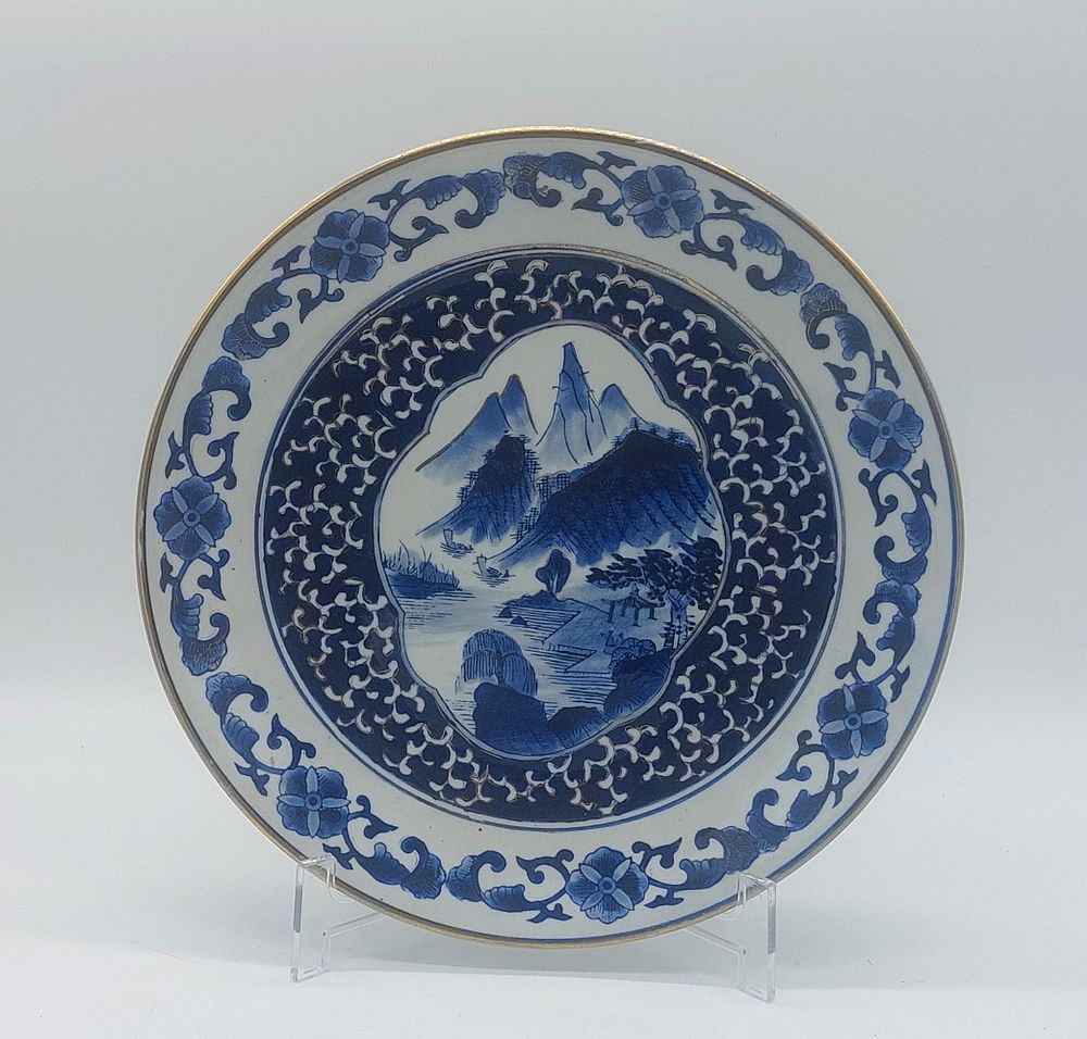 Japanese Porcelain Plate
. Molded and embossed, marked at the base, with a gold-trimmed rim, and 
