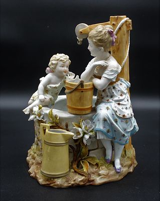 Sculpture in European Porcelain. Marked on the folder, representing a girl and a cherub sitting 