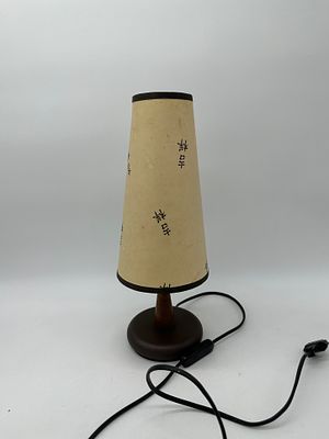 Table Lamp
. Round metal and wood base with paper lampshade with Chinese characters, with slight 