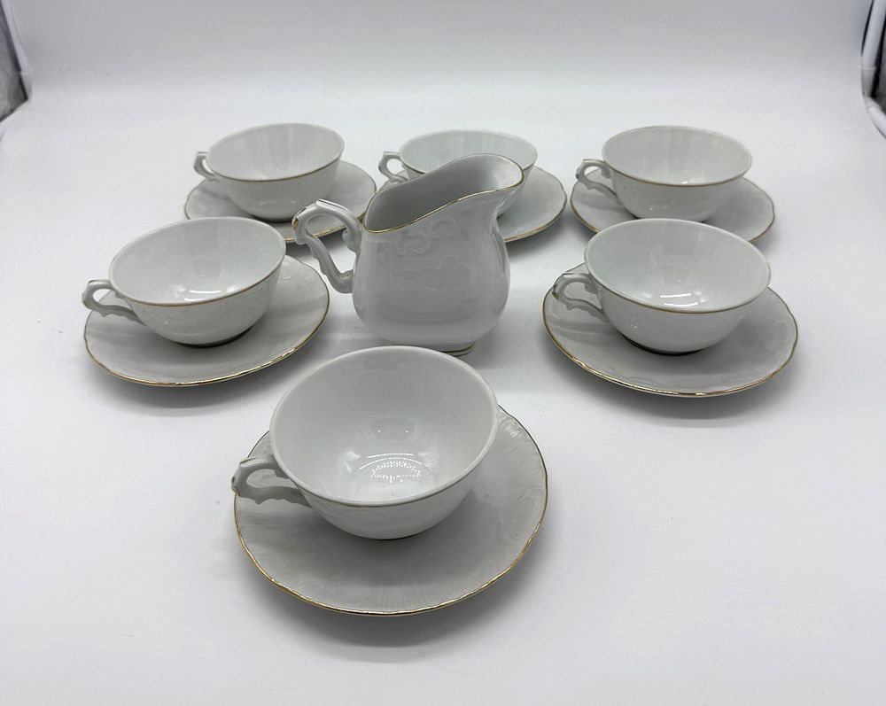 Six Tea Cups and Milk Jug in Portuguese Porcelain
. Molded and embossed, marked on the base MG 
