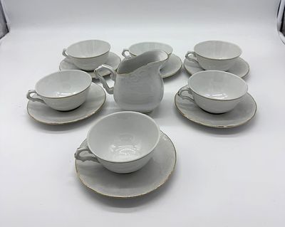 Six Tea Cups and Milk Jug in Portuguese Porcelain
. Molded and embossed, marked on the base MG 