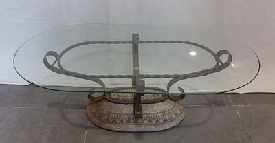 Oval Stone Coffee Table
. Oval-shaped glass top supported by twisted metal and stone powder base 