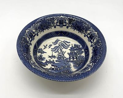 English Earthenware Bowl
. Round-bodied vessel with blue decoration in an Oriental style on a 