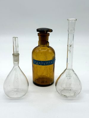 Three Laboratory and Pharmacy Bottles
. Two volumetric flasks and an amber pharmacy bottle 