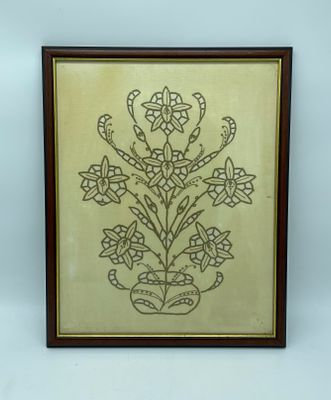 Embroidery frame. Frame with embroidery on canvas depicting floral motifs. Wooden plaque frame 
