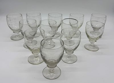 Twelve Cut Glass Cups
. Conical-shaped bodies supported on a round base, with chiseled relief 