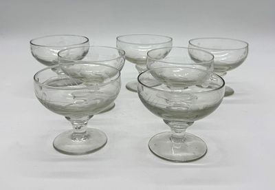 Seven Cut Glass Goblets
. Conical-shaped bodies supported on a round base, with chiseled relief 