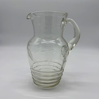 Faceted Glass Mug
. Cylindrical body with openwork handle, chiseled relief decoration of grapes 
