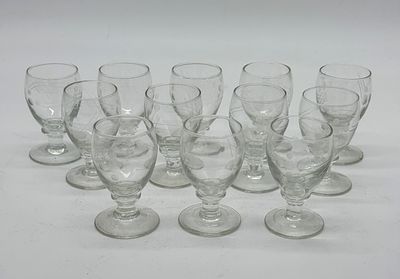 Twelve Cut Glass Cups
. Conical-shaped bodies supported on a round base, with chiseled relief 