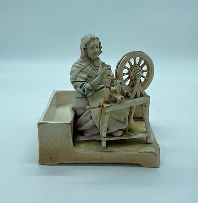 Sculpture in European Porcelain. Portuguese porcelain sculpture depicting a woman spinning on a 