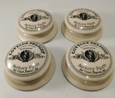 4 X 'COTTAGE DELIGHT - GENUINE ANCHOVY PASTE' HEAVY CERAMIC PAPERWEIGHTS IN THE STYLE OF AN 